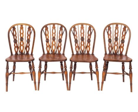 A set of four elm, ash and beech kitchen chairs, first half 19th century; the openwork hoop backs each with pierced and round
