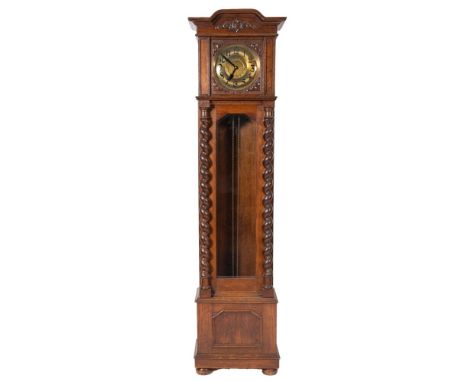An Edwardian German oak longcase clock having a weight-driven movement striking the hours on two gong-rods and the quarters o