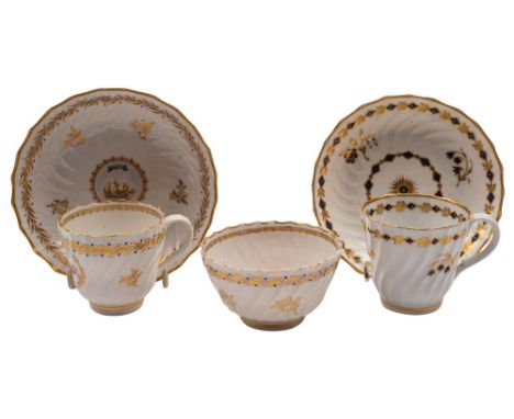 A Caughley 'L'Amitie' spiral-fluted trio and a similar blue and gilt cup and saucer the first painted with two doves below th