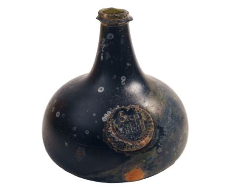 A sealed pancake onion wine bottle, of black colour and  squat form with short tapering neck and string rim and kick up, appl