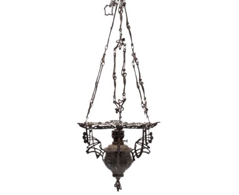 A cast and repousse worked metal rise and fall pendant oil lamp, in Art Nouveau taste, early 20th century; with domed milk gl