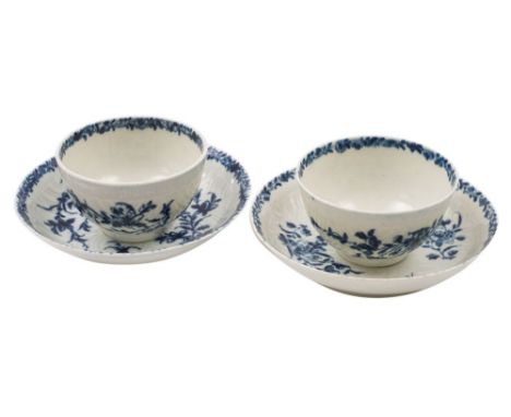A pair of First Period Worcester blue and white tea bowls and saucers in the Feather Mould Floral pattern, open crescent mark