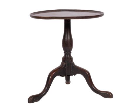 A George II mahogany circular tripod table, mid 18th century; the top with ribbed edging, above a baluster stem, to splayed l