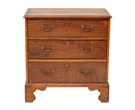 A George III oak chest of drawers, last quarter 18th century; the top with moulded front and side edges; the three long drawe