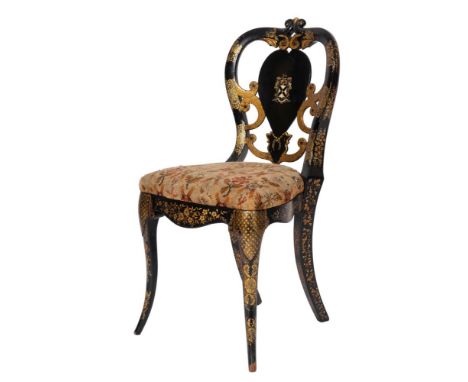 A Victorian black lacquered and parcel gilt side chair, circa 1865; the openwork waisted backrest with painted armorial and t