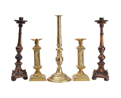 A pair of Continental, probably Italian, carved and stained walnut altar candlesticks, 20th century and elements possibly ear