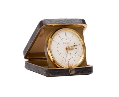 Chandler, a small Edwardian snake skin travelling clock the round dial with baton numerals, dauphine hands and alarm setting 