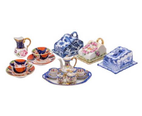 A group of miniature porcelains, comprising a Continental tête a tête and tray, a pair of tea cups and saucers, an octagonal 