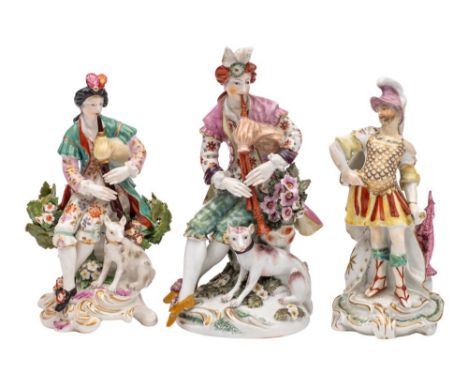 A group of three Derby figures comprising two figures of shepherds each playing the bagpipes with a hound at their feet, one 