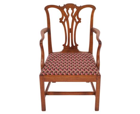 A George III mahogany elbow chair in Chippendale style, last quarter 18th century; the backrest with openwork vase form ribbo