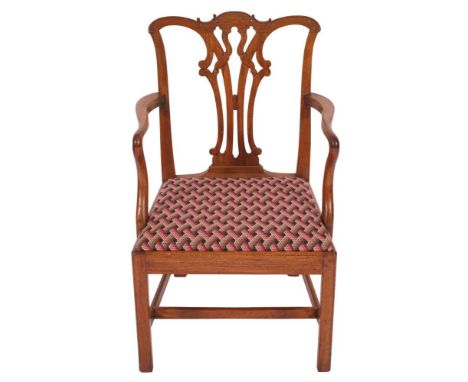 A George III mahogany elbow chair in Chippendale style, last quarter 18th century; the backrest with openwork vase form ribbo