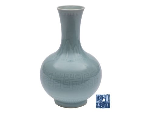 A Chinese bottle vase the pale greenish-blue glaze decorated with stiff plantain leaves, diaper and key pattern bands, apocry