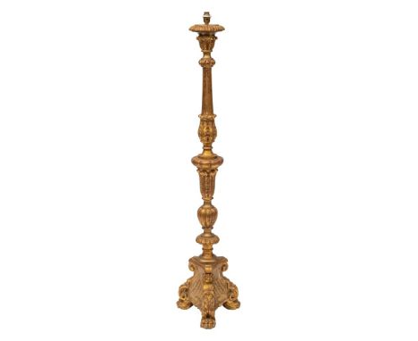 A Continental carved and giltwood standard lamp in early 18th century taste, 20th century; with electrical fitment above a sh
