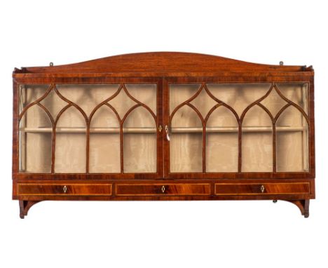 A Regency mahogany and glazed wall hanging display cabinet, early 19th century; the three quarter gallery with shallow arched