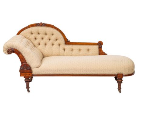 A Victorian walnut and button upholstered chaise longue in Neoclassical style, late 19th century; the arched backrest with a 