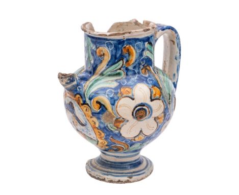 An Italian maiolica wet drug jar painted with a portrait cartouche on a blue ground of flowers and scrolling foliage, Caltagi