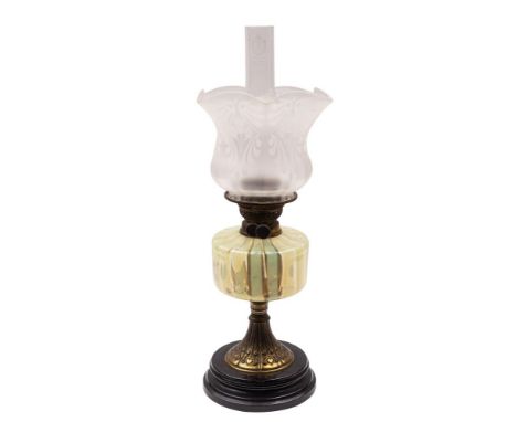 A Victorian gilt metal and glass table oil lamp, circa 1900; the etched opaque glass shade with crimped upper edges, around t