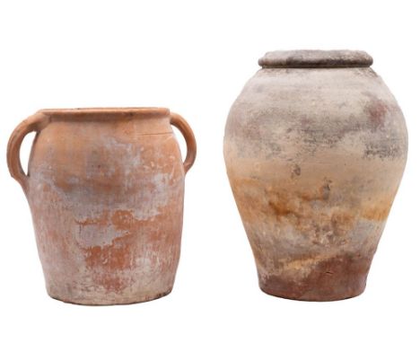 Two terracotta garden pots,  the first of oviform with rolled rim the other of tapering cylindrical form with a pair of lug h