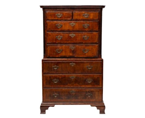 A late George II or George III walnut, crossbanded and feather banded chest on chest, circa 1760; the upper section with moul
