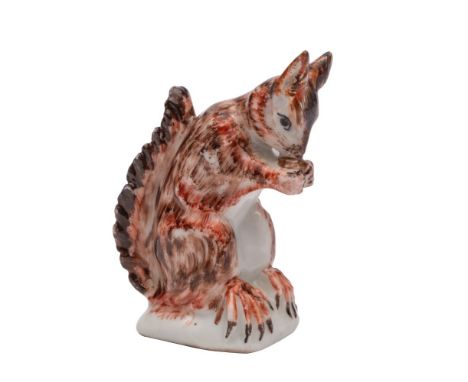 A Bow model of a red squirrel of small size, eating a nut held between its front paws, circa 1752-55, 5.5cm [ears restored].