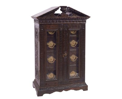 A Victorian carved oak table top cigar and cigarette cabinet, for Army &amp; Navy CSL, late 19th century; of architectural fo