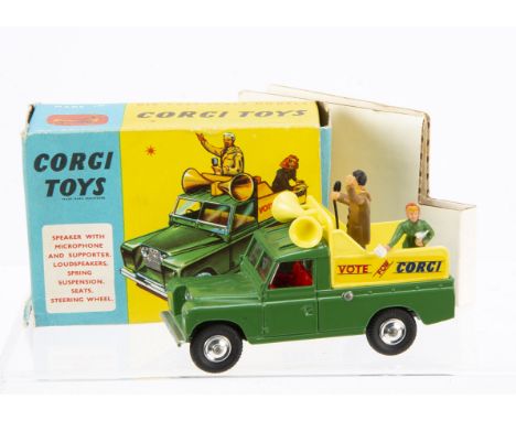 A Corgi Toys 472 Land Rover Public Address Vehicle, green body, red interior, yellow back, 'Vote For Corgi' decals, two figur