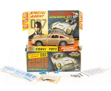 A Corgi Toys 261 James Bond's Aston Martin D.B.5, gold body, red interior, wire wheels, Bandit figure, in original box with i