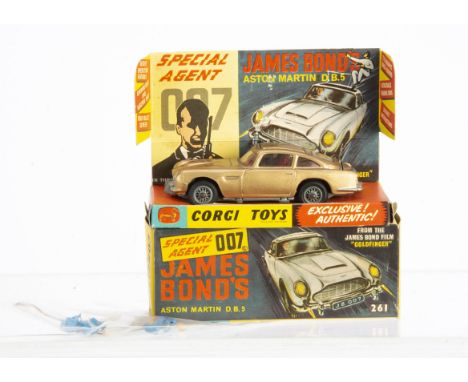 A Corgi Toys 261 James Bond's Aston Martin D.B.5, gold body, red interior, wire wheels, Bandit figure, in original box with i