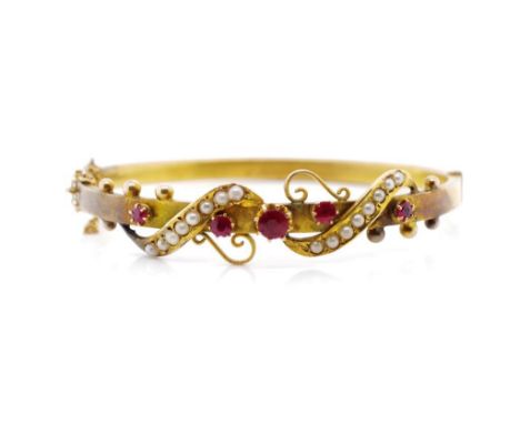 Australian 9ct yellow gold bangle set with seed pearls and red paste. Marked 9 crown lion to tang possibly for Brunkhurst or 