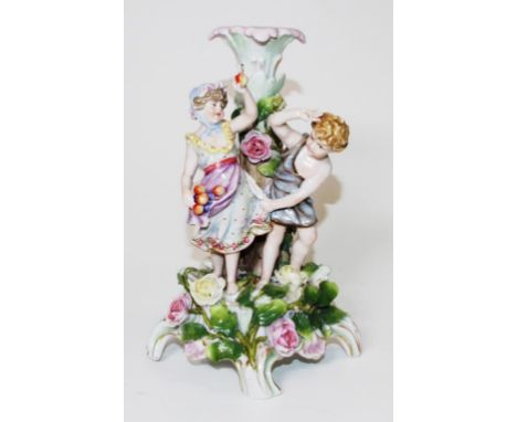 Vintage ornamental ceramic figural candlestick figures of a Boy and Girl collecting fruit, supporting an ornamental candlesti