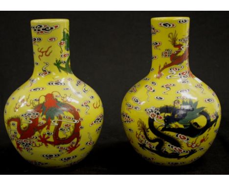 Vintage pair Chinese hand painted mantle vases each with dragon figure decorated on yellow ground, character mark to bases, (
