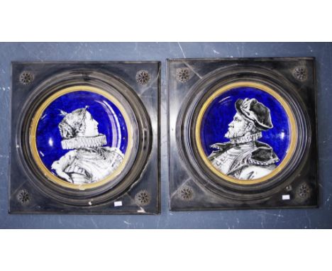 Pair Montereau France faience ceramic plaques each depicting an Etruscan portrait on ceramic plaque, in original carved wood 