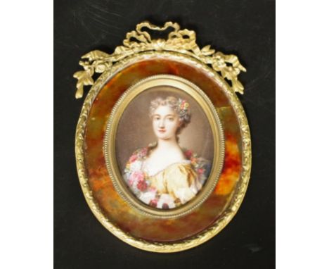 Antique brass framed portrait miniature hand painted portrait of a Woman in formal dress, in decorative brass oval frame, wit