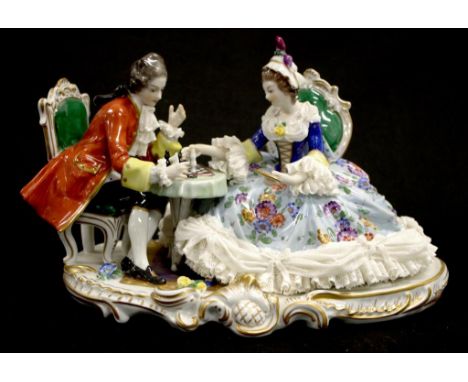 Good Dresden figure of Couple Playing Chess seated man and woman playing chess, (height 17cm, length 27cm approx).