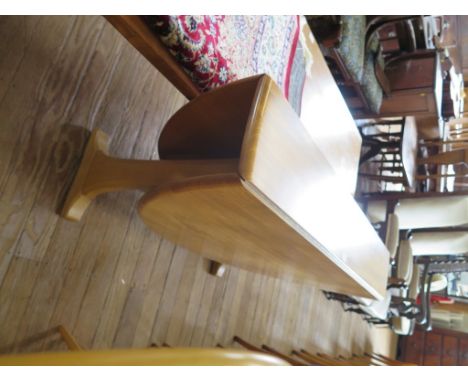 An Ercol light elm narrow drop leaf dining table with beech supports 128cm wide, 140cm open and four Ercol Windsor Quaker typ