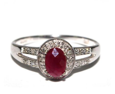 A ruby and diamond ring set in white gold