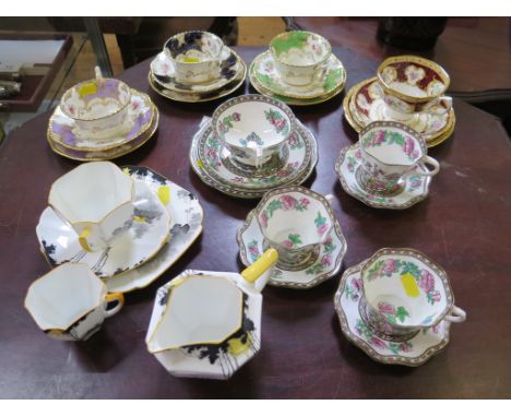 Three Coalport teacup, saucer and plate sets with floral decoration with purple, blue or green borders, a Shelley part tea se