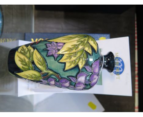 A Moorcroft Pottery 'Wisteria' design vase, in purple, marked trial 16.11.99 and signed by designer Philip Gibson, 15cm high,