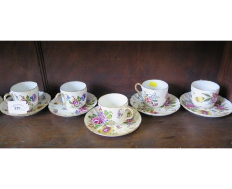 A set of ten German porcelain cup and saucers, each with painted floral decoration, 7.5cm high, tied cross baton mark