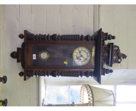 A 19th century walnut Vienna type wall clock, the mask and turned pediment surmounted by a horse, over a  dial marked for Gus