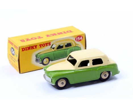 Dinky Toys No. 154 Hillman Minx Saloon, green lower and cream upper body, cream hubs, type 2 casting with 'Hillman Minx' to t