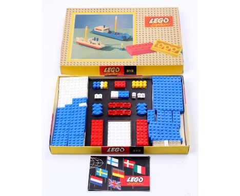 A vintage Lego System No. 312 Boat set containing blue, red, yellow and white bricks to construct 2 different boats, all hous