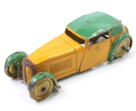 A Dinky Toys pre-war No. 22B closed sports coupe comprising yellow and green body with gold washed coloured wheels, tinplate 