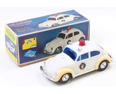 HC Toys Hong Kong plastic battery-operated Volkswagen Beetle Police Car comprising of a white body with chrome bumpers and re