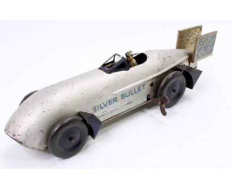 An unusual tinplate and clockwork model of a Silver Bullet landspeed record car comprising of silver body with blue fins, bla