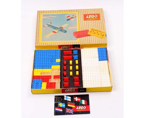 A vintage Lego System No. 311 Aircraft construction set containing a selection of red, white, blue and clear bricks to make a
