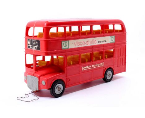 A Tudor Rose vintage plastic Routemaster London Bus in red with yellow seats, with "London Transport" &amp; "BP" labels
