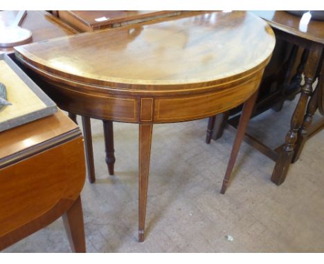 An Edwardian Folding Card Table, with burgundy baize and decorative inlay, on tapered legs (wf), approx 94 x 47 x 75 cms.