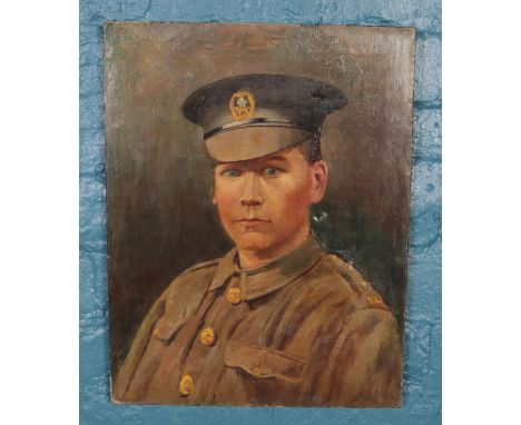 An unsigned oil on canvas. Depicting a portrait of a WWI soldier. (46cm x 36cm)  Some tears to the canvas.