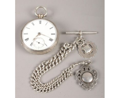 A Victorian silver pocket watch, together with fob chain and fobs; the watch with enameled dial and roman numeral markings. C